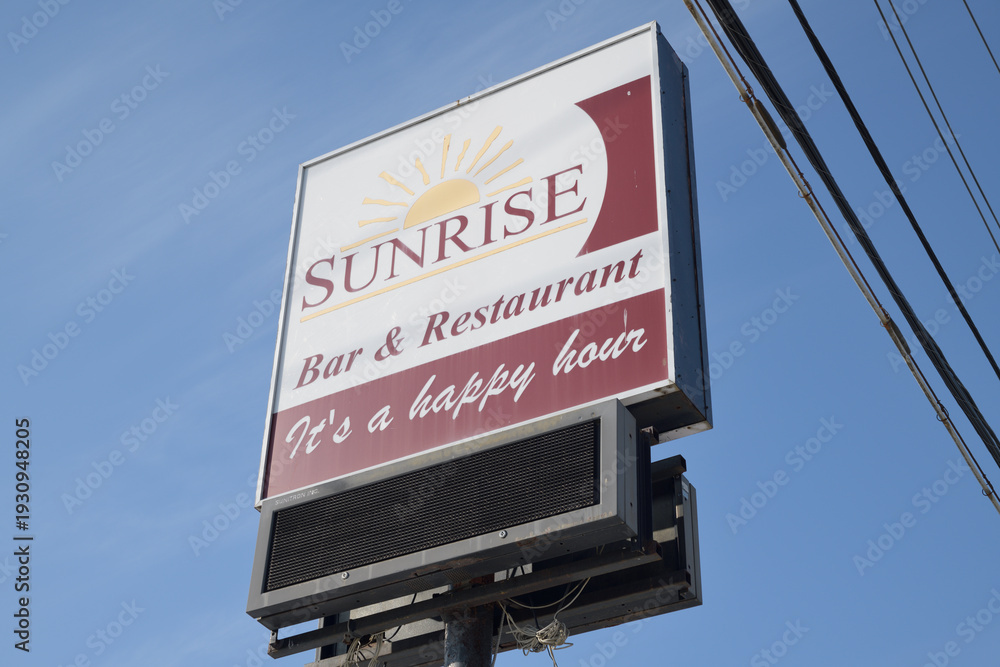 Fototapeta premium road side pylon sign of Sunrise Bar & Grill located at 1416 Victoria Park Av, North York, Toronto