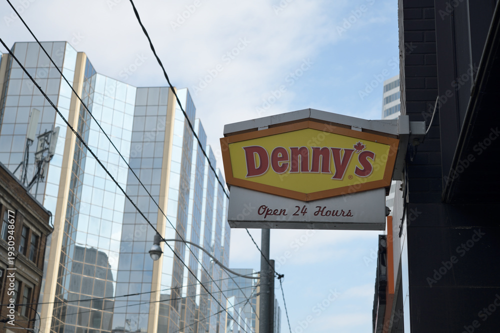 Obraz premium wall mounted projecting sign outside Denny's, a diner chain, located here at 121 Dundas St W, Toronto
