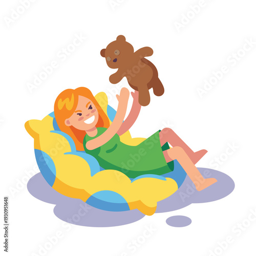 Happy girl playing with teddy bear on bean bag chair.