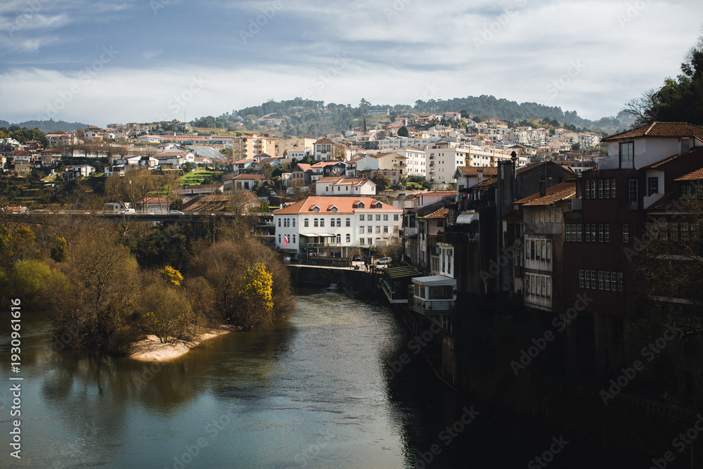 Fototapeta premium Panoramic view of Amarante with houses along the river, hillside neighborhoods and soft winter light over the Tamega valley.