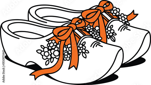Dutch wooden clogs with orange ribbons and blooming flowers