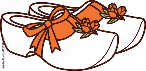 Dutch wooden clogs with orange ribbons and blooming flowers