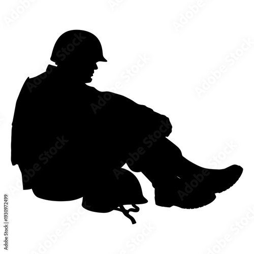 Silhouette of a seated person wearing a helmet in profile.