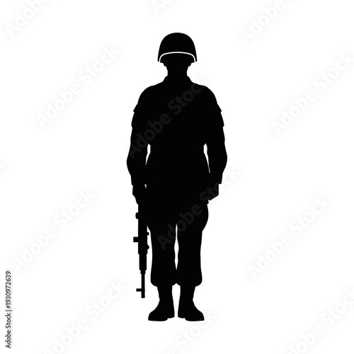 Silhouette of a armed soldier standing with rifle in helmet in stark contrast.