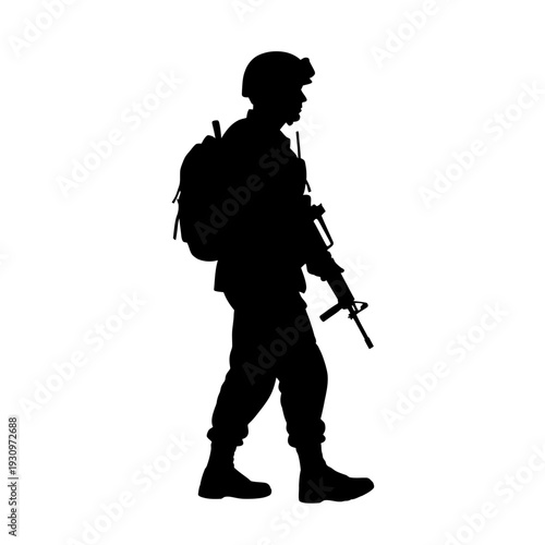 Silhouette of a soldier with backpack and rifle standing in a field.
