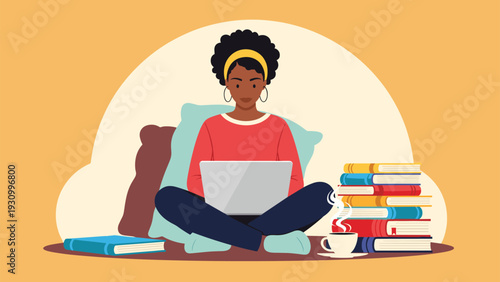 Young woman sitting cross legged on the floor and working on a laptop with a large stack of books and a cup of coffee.