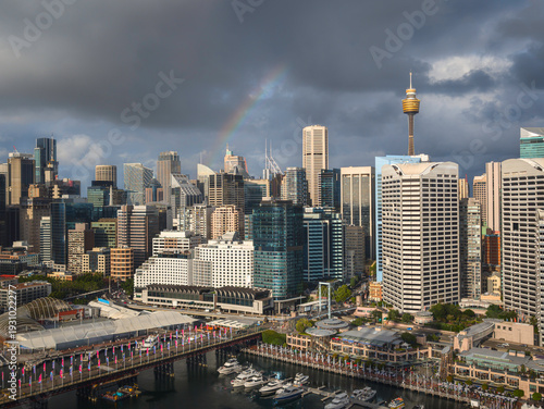 Rainbow in rain over Sydney Skyline.