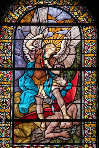 Stained glass (1916) of Saint Michel the Archangel killing a demon.
