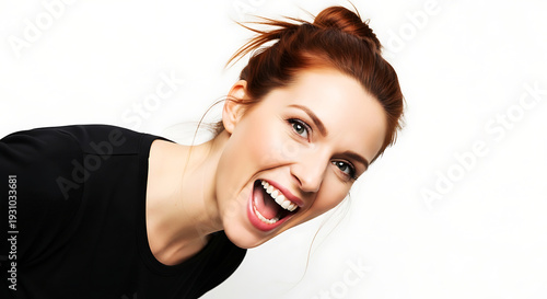Young woman with red hair shouting with joy and excitement against white background
