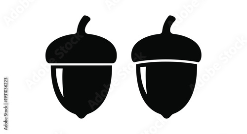 Two black silhouettes of acorns displayed against a white background