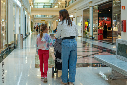фотографія Mother and daughter going to the supermarket for groceries together, everyday family life and learning life skills concept