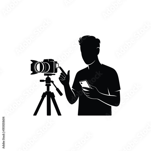 Silhouette of a man operating a video camera on a tripod stand