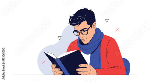 Focused young man wearing glasses and a blue scarf sitting at a desk while intently reading a large black book.