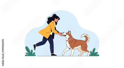 Happy young woman in a yellow jacket leans forward to give a delicious treat to her brown and white dog in a peaceful park setting.