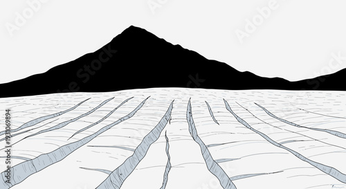 stark landscape featuring expansive glacial cracks beneath a vast dark mountain range