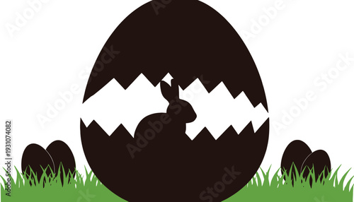 Silhouette of a rabbit emerging from a cracked easter egg in grass.