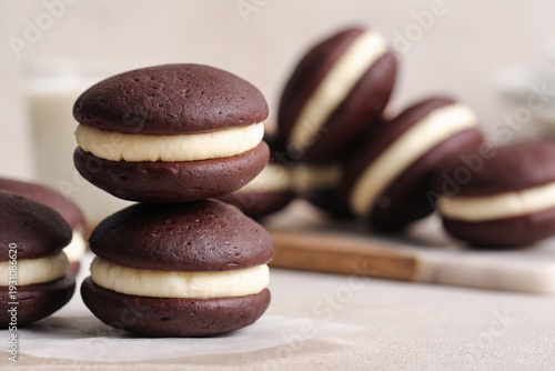 Photos Sweet chocolate whoopie pies on light table, closeup