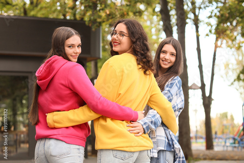 Happy teenage girls hugging...