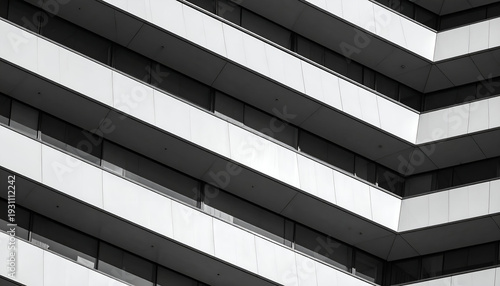 Angled black and white photo of a modern building facade with recessed balconies