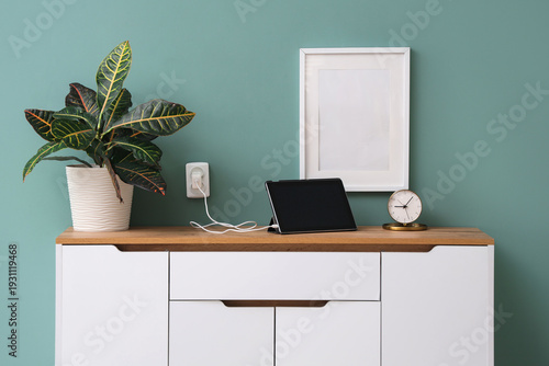 Modern tablet with charger ...