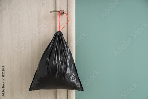 Full garbage bag hanging on...