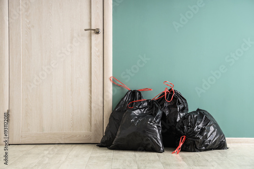 Full garbage bags on floor ...