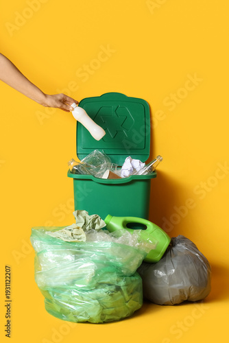 Woman throwing bottle into ...