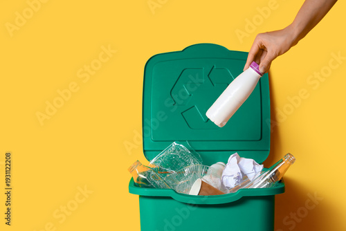 Woman throwing bottle into ...