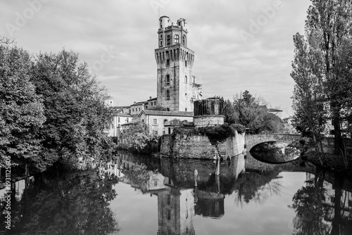 Specola museum with water reflections in Padua, Veneto, Italy; museum of the astronomical observatory of Padua on river Bacchiglione  waterfront in black and white
