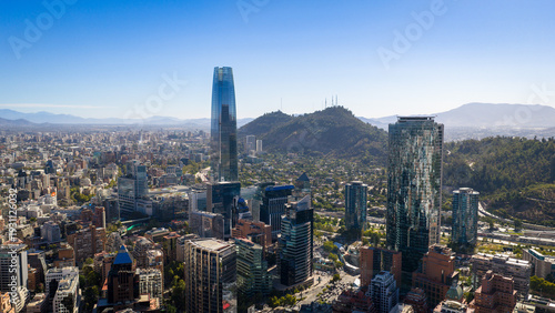 Obraz na płótnie Aerial skyline of Santiago de Chile with modern towers and urban hills under clear blue sky