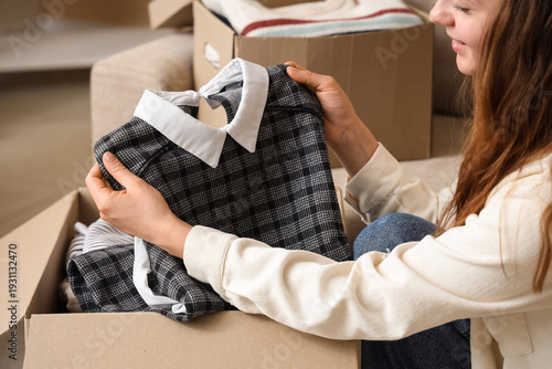 Young woman unpacking cardb...