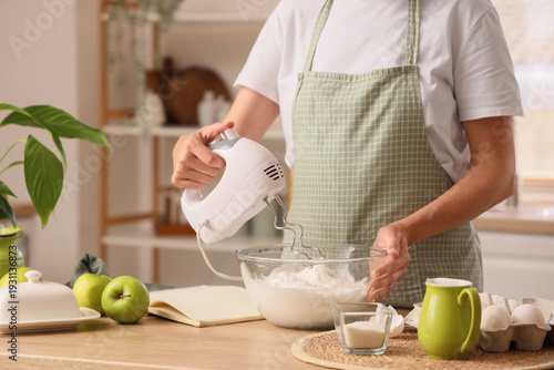 Woman whipping egg whites w...