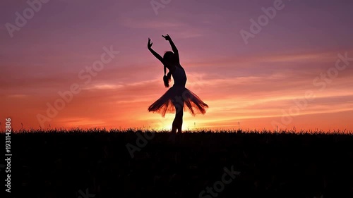 Wide close-up silhouette view of a little girl performing slow, expressive dance movements on a hill