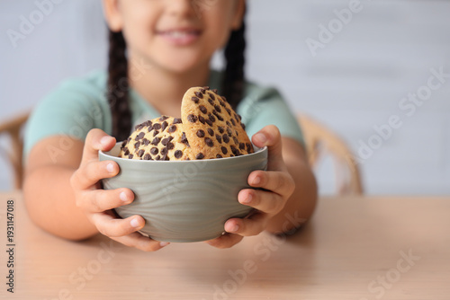 Little girl with bowl of co...
