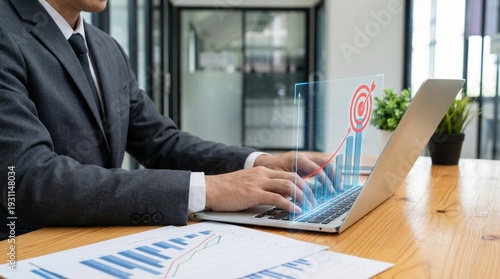 Tableau sur toile Business professional analyzing data and growth projections on a laptop