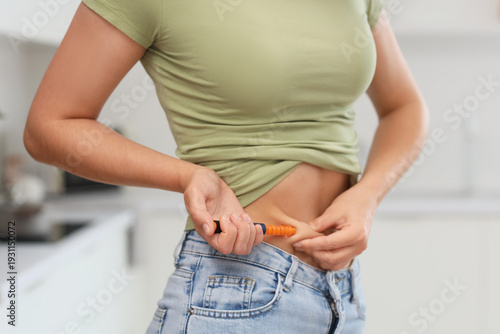 Foto Young woman injecting herself with hormones for IVF in kitchen, closeup