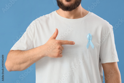 Young man pointing at blue ...