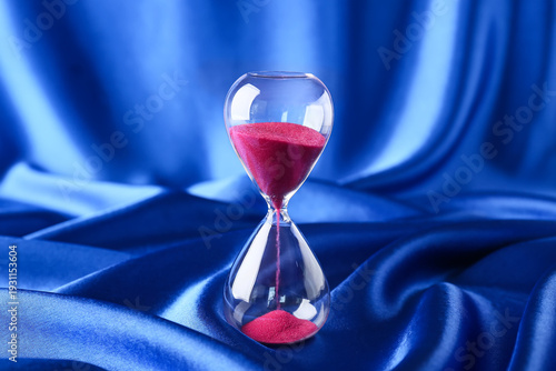 Crystal hourglass on blue b...