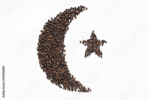 Crescent and star made of peppercorns as symbol of Islam on white background