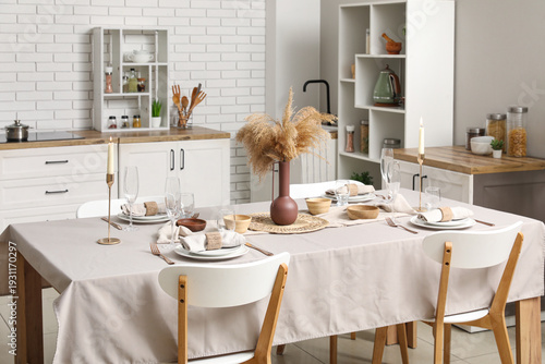 Stylish table setting for dinner in kitchen
