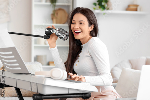 Singing young woman with mi...