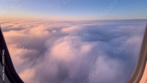 Stunning Aerial View of Clouds from Airplane Window During Sunset Flight.