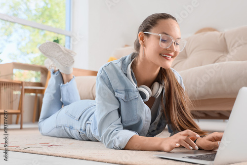 Young woman using laptop on...