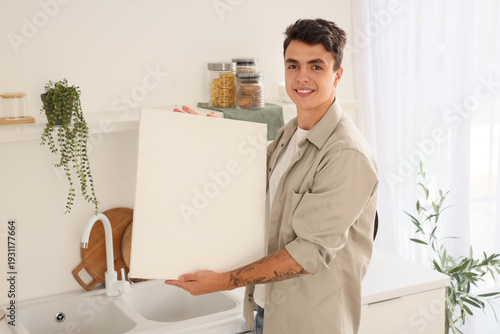 Young man with painting in ...