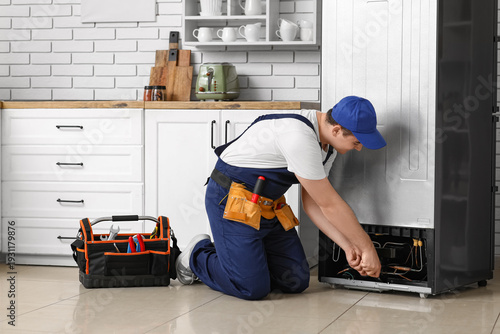 Male worker with tools repa...