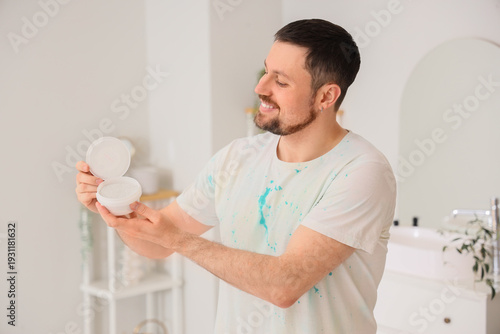 Young man with tooth powder...