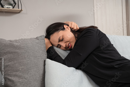 Depressed young woman sitti...