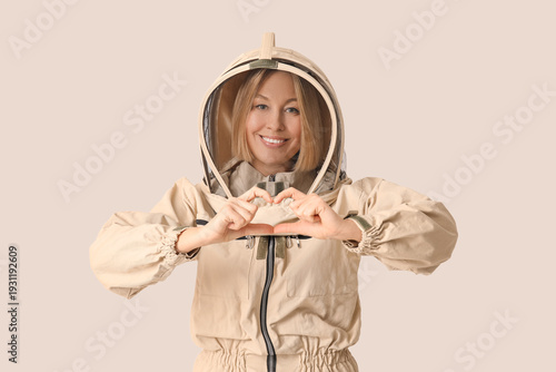 Female beekeeper showing he...
