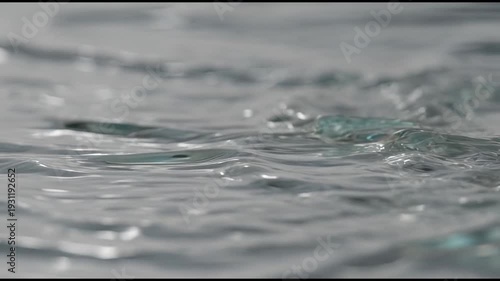 Close-up view of water droplets creating ripples on a water surface
