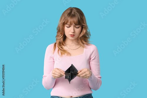 Sad young woman holding emp...